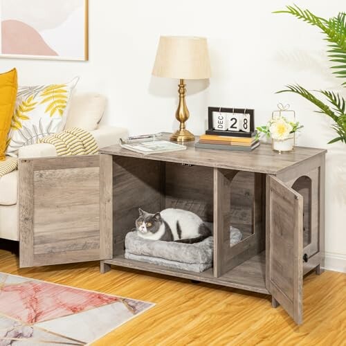 Cat resting in a wooden cabinet with open doors in a cozy living room.