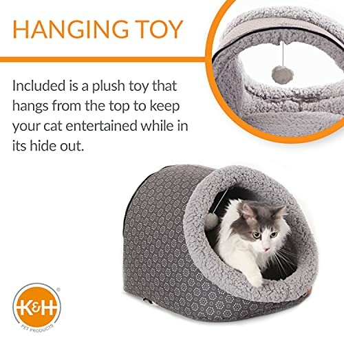 Cat inside a cozy pet shelter with a hanging toy.
