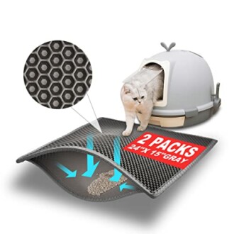 Cat exiting litter box onto a honeycomb mat designed to trap litter.