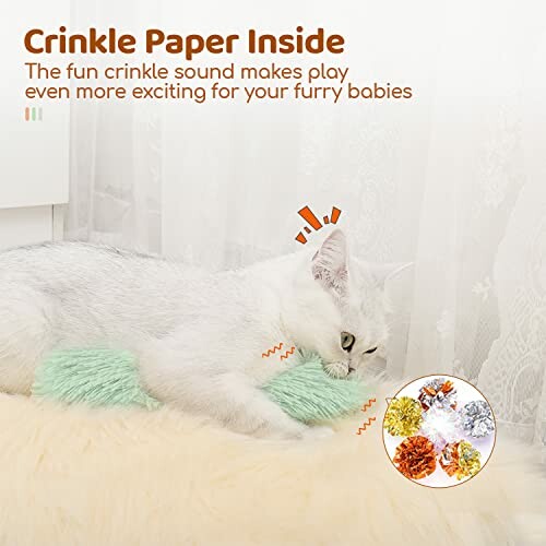 White cat playing with crinkle paper toy on a fluffy surface.