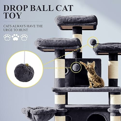 Cat playing with drop ball toy on a cat tree.
