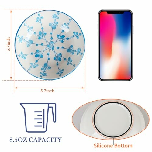 Ceramic bowl with blue floral design, shown next to a smartphone for size comparison.