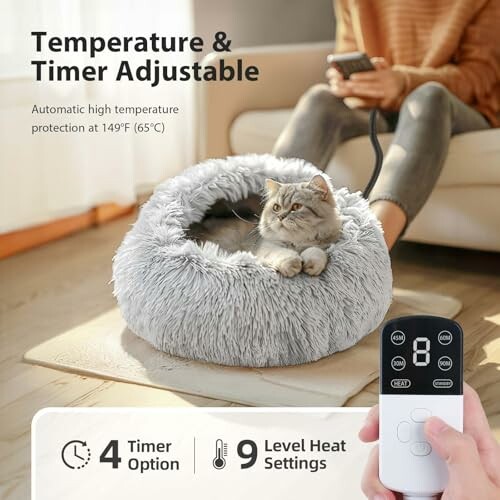 Cat in a heated bed with temperature and timer controls, person holding remote.
