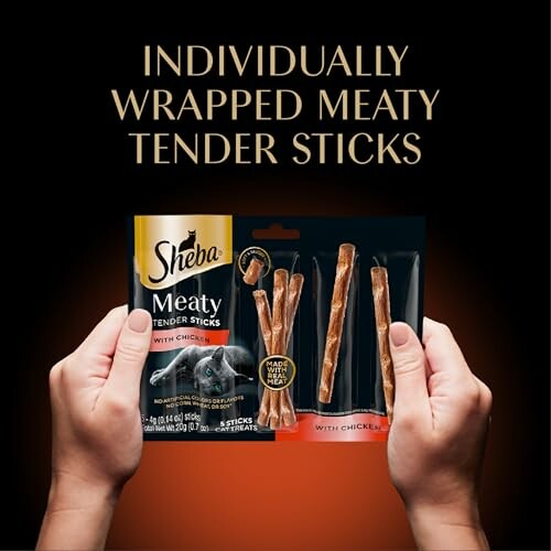 Hands holding Sheba Meaty Tender Sticks package.