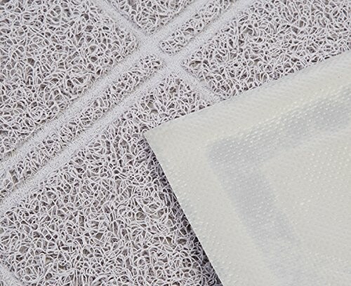 Close-up of a textured floor mat with a mesh design